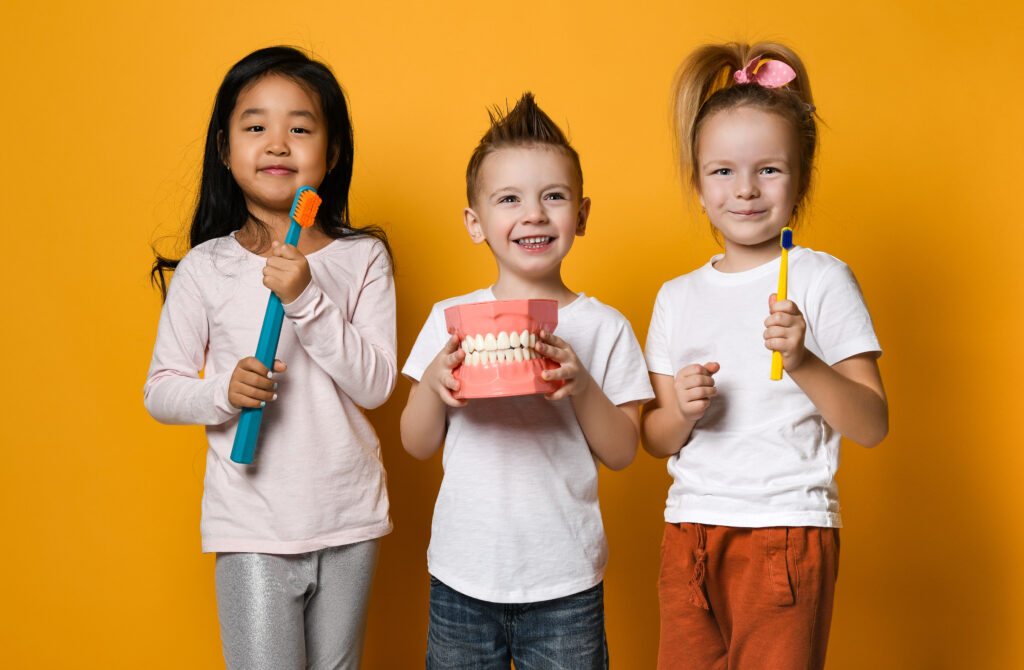 happy little cute children with toothbrushes. dental hygiene-Forest Hill Family Dental